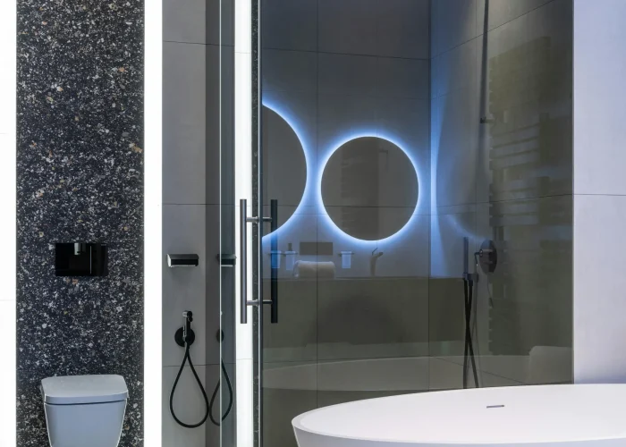 Luxury bathroom remodel Walnut Creek CA with freestanding tub, LED mirror, and contemporary black tile accent wall